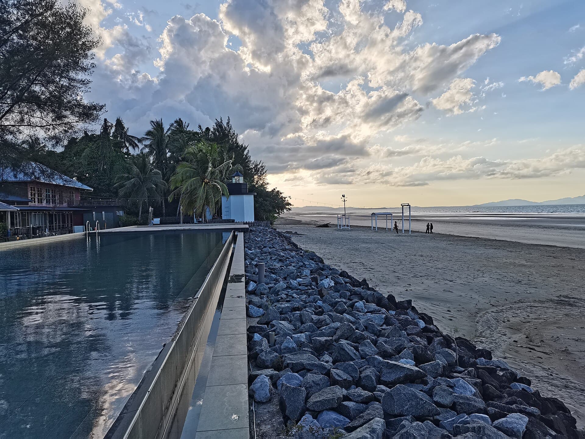 Resort swimming pool lined with palm trees